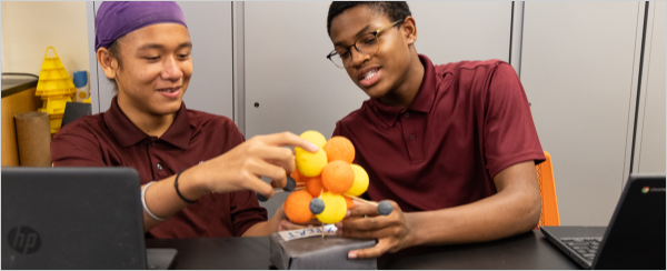 Two male students working on a science project